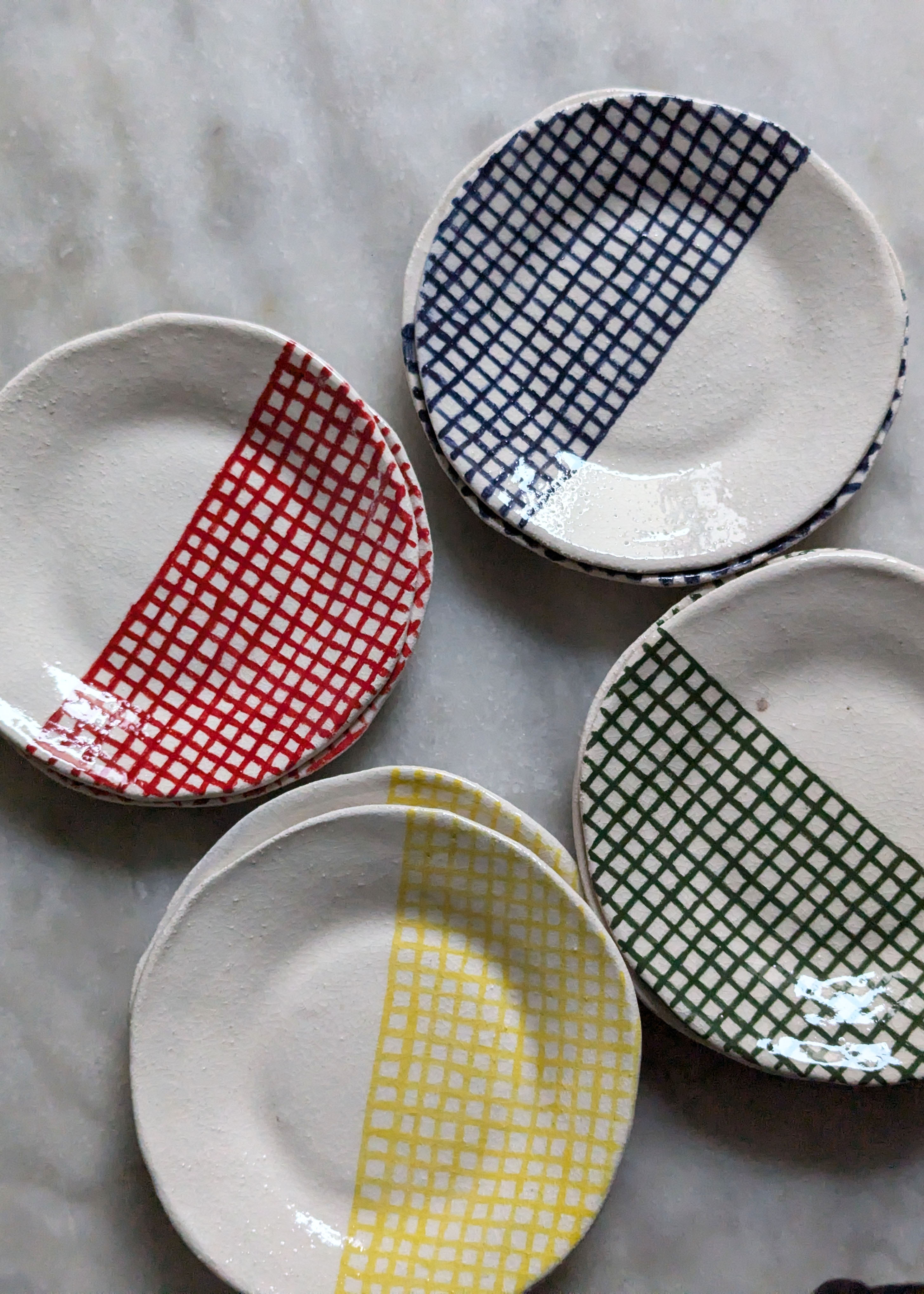 assiettes à dessert en faïences blanche émaillée avec des carreaux peints en bleu, rouge, vert et jaune